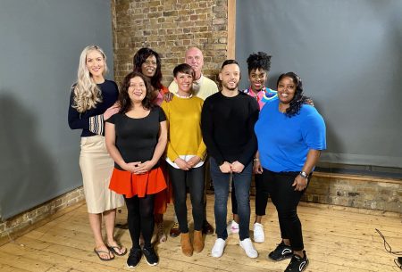 Dr Megan Rossi standing in a room with seven additional people she has connected with through gut health research