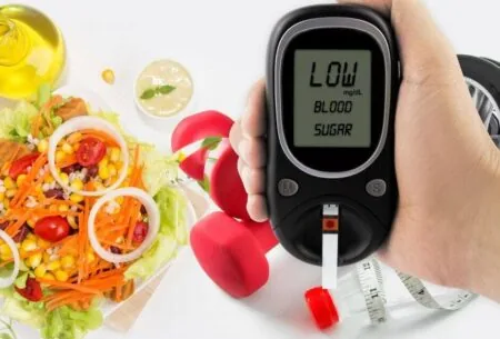 blood sugar testing device with a background of gym equipment and a salad
