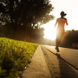 A photo of a woman running in the early morning