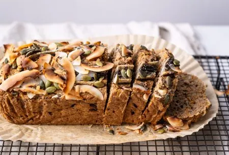 A photo of the banana, fig & courgette loaf, sliced and placed on the table