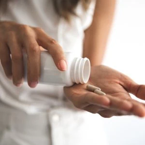 A photo of a woman having some supplements