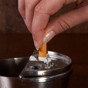 A photo of a cigarette being put out