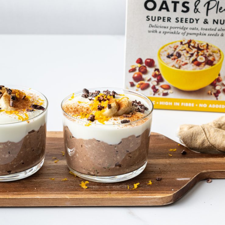 A photo of two cups of overnight oats topped with yoghurt