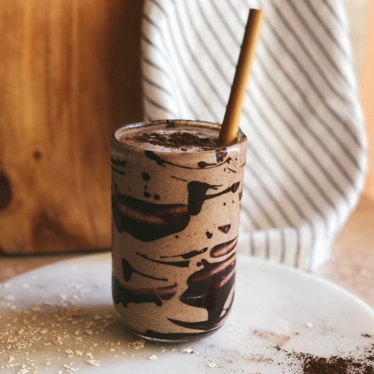 A photo of the super six coffee smoothie with a straw in it