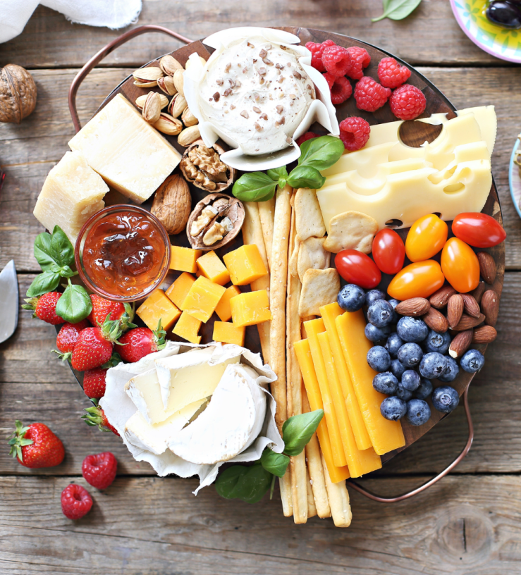 Photo of a plant-diverse platter including fruit and cheeses to show workplace wellbeing